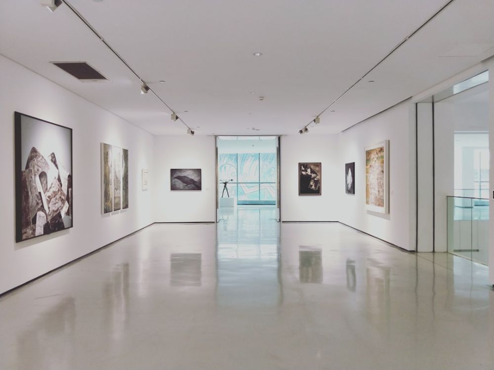 Art Gallery - assorted paintings on white painted wall