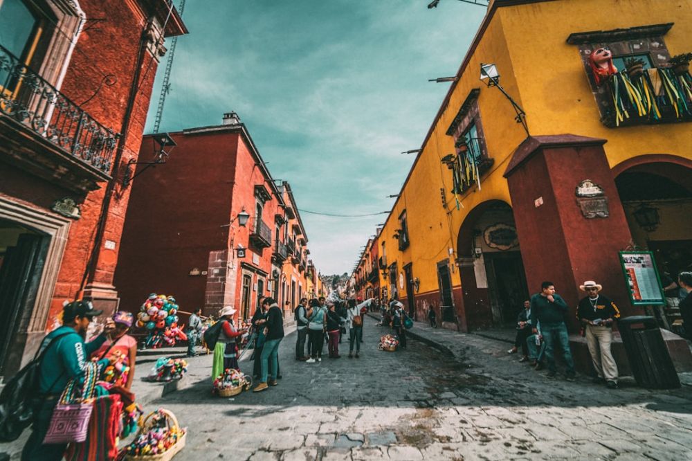 Mexico Culinary Tour - people standing on corner road near concrete buildings during daytime