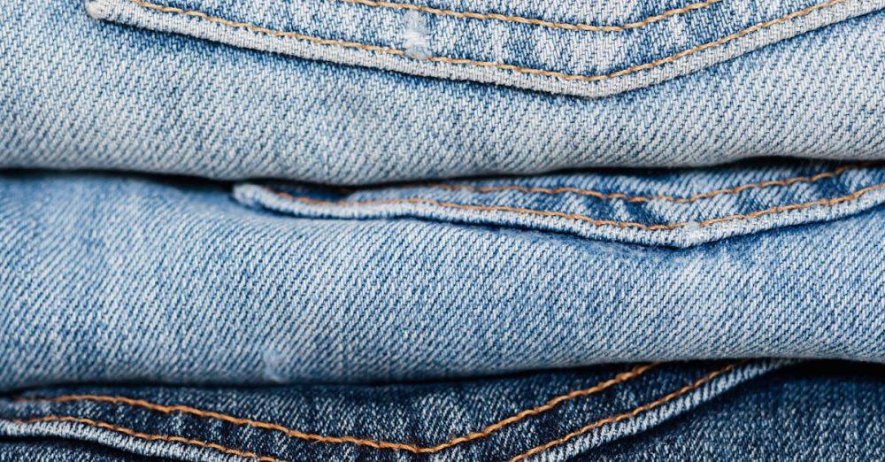 Textile Markets - Stack of blue jeans arranged by color