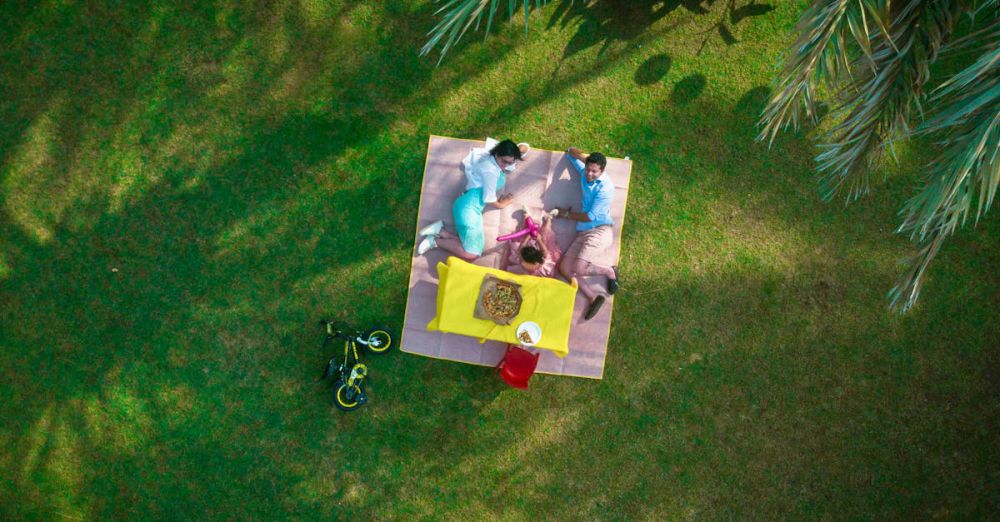 Family Picnic - Man And Woman Laying On Picnic Mat