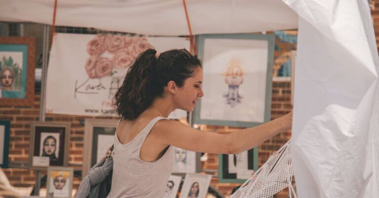 Art Walk - Woman Standing Near Paintings Holding White Hammock